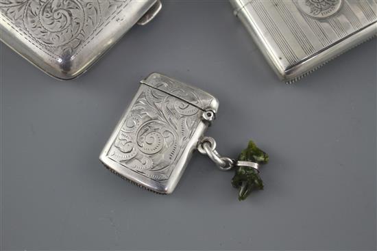 An Edwardian engraved silver cigarette case, Samuel M. Levi, Birmingham, 1905 and two similar vesta cases,